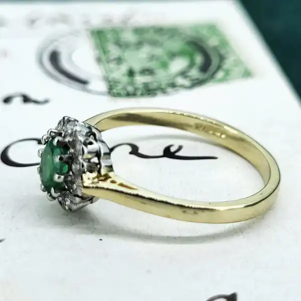 9ct Gold Emerald and Diamond Cluster Ring-9ct-emerald-and-diamond-oval-cluster-ring.webp