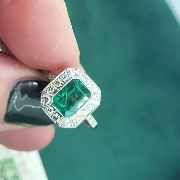 Platinum Emerald and Diamond Ring-platinum-emerald-diamond-cluster-with-milgrain-detailing.webp